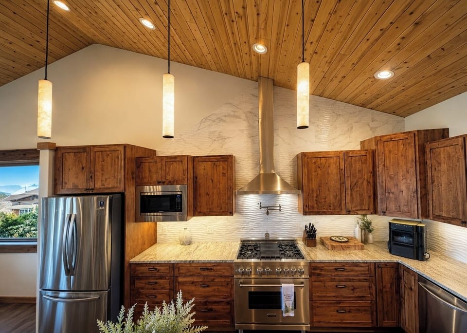 Upscale rustic kitchen with vaulted wood ceilings and chef-style range