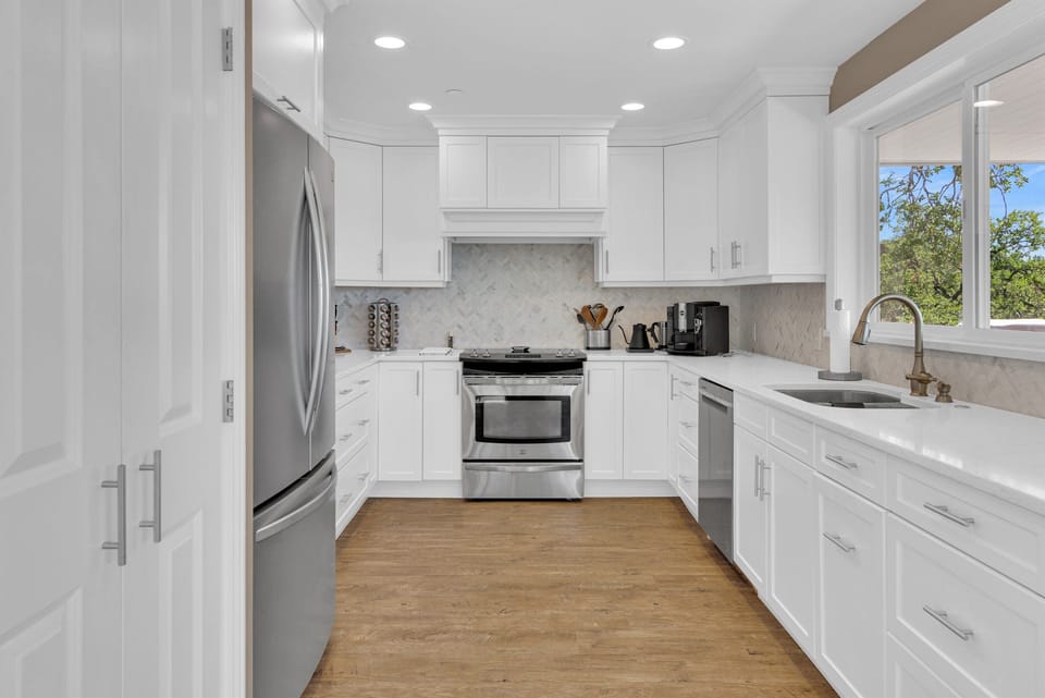 Bright, remodeled kitchen with lake views and plenty of space for gathering and cooking together.