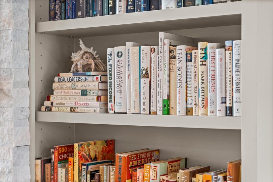 Built-in bookshelf with curated decor and reading collection adding warmth to the living space.