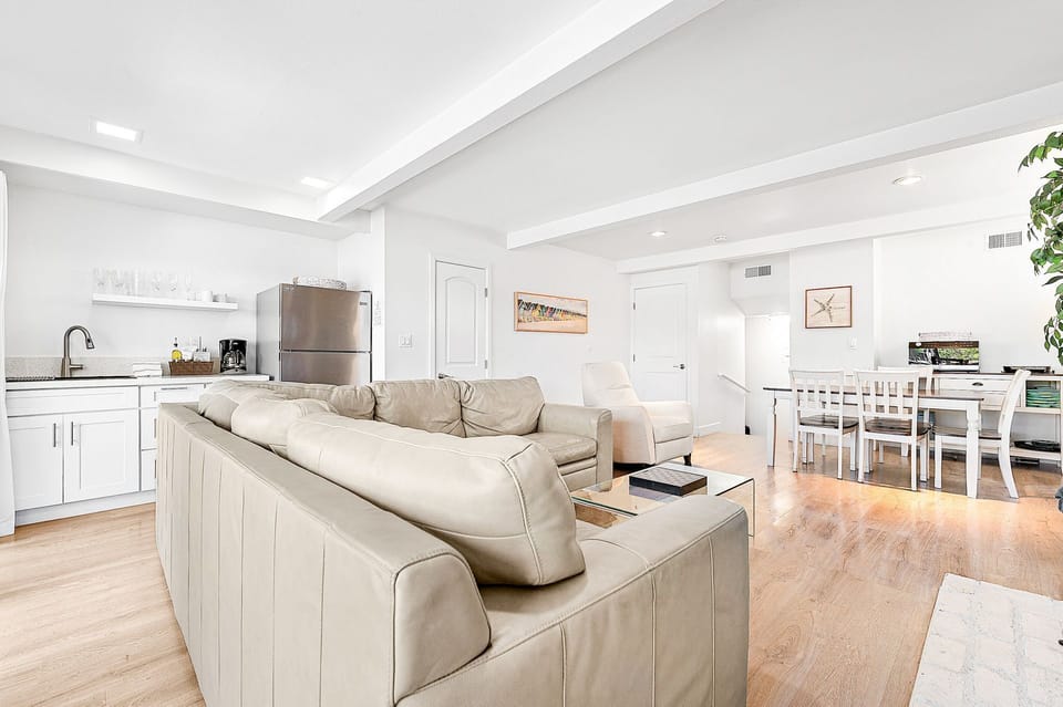 The view of the living room and dining area from the front sliding glass doors.
                