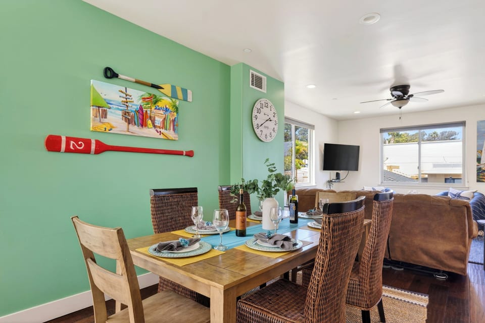 Vibrant seafoam green accent walls bring a fresh, beachy energy directly into the dining space.