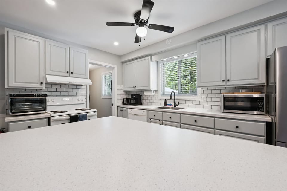 Stylish and spacious kitchen with stainless steel appliances and ample counter space for cooking together.
