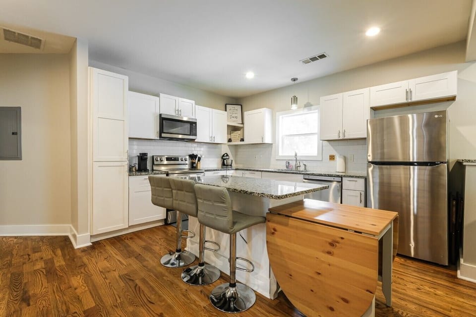 Prepare your favorite meals in this bright kitchen equipped with modern stainless steel appliances and bar seating for casual dining.