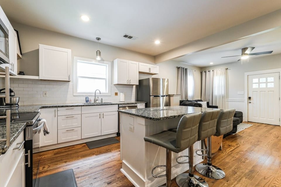 Prepare your favorite meals in this bright kitchen equipped with modern stainless steel appliances and bar seating for casual dining.