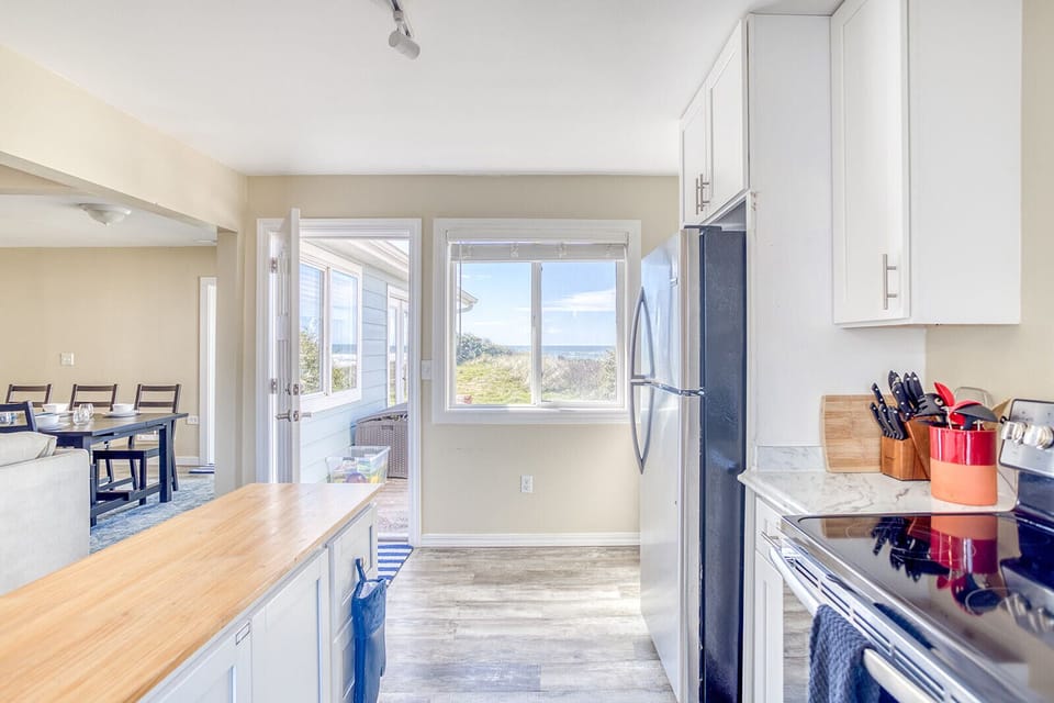 Your spacious kitchen flows seamlessly into the dining area, with natural light streaming through windows that frame stunning landscape views.