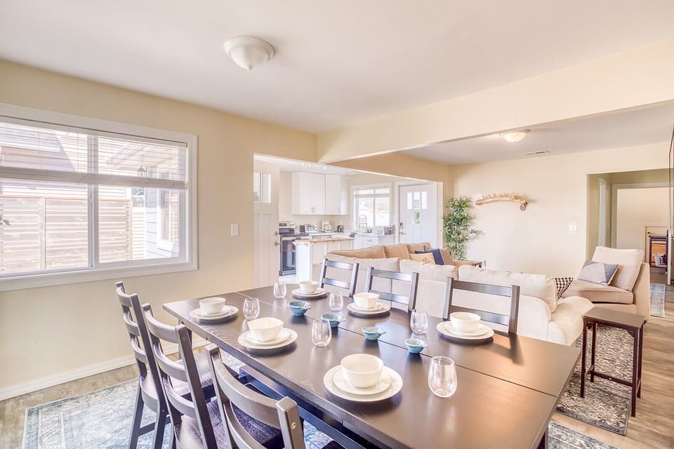 Gather around this spacious dining table where your group can share memorable meals together in this bright, open-concept space.