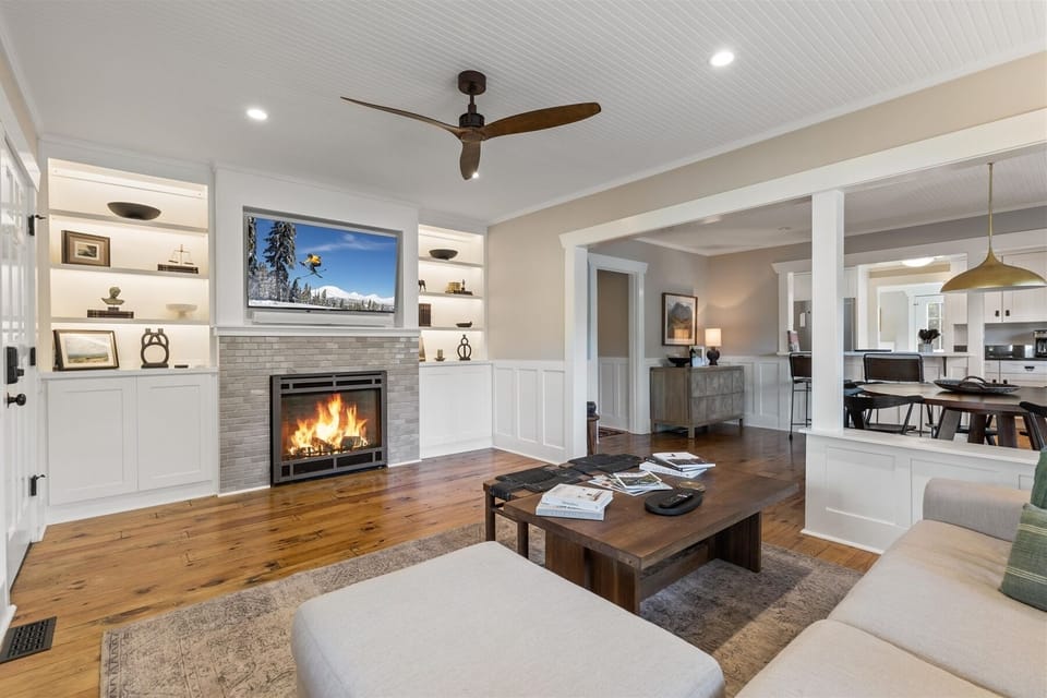 Living room with a fireplace and 55" smart TV with Sonos wireless sound system.