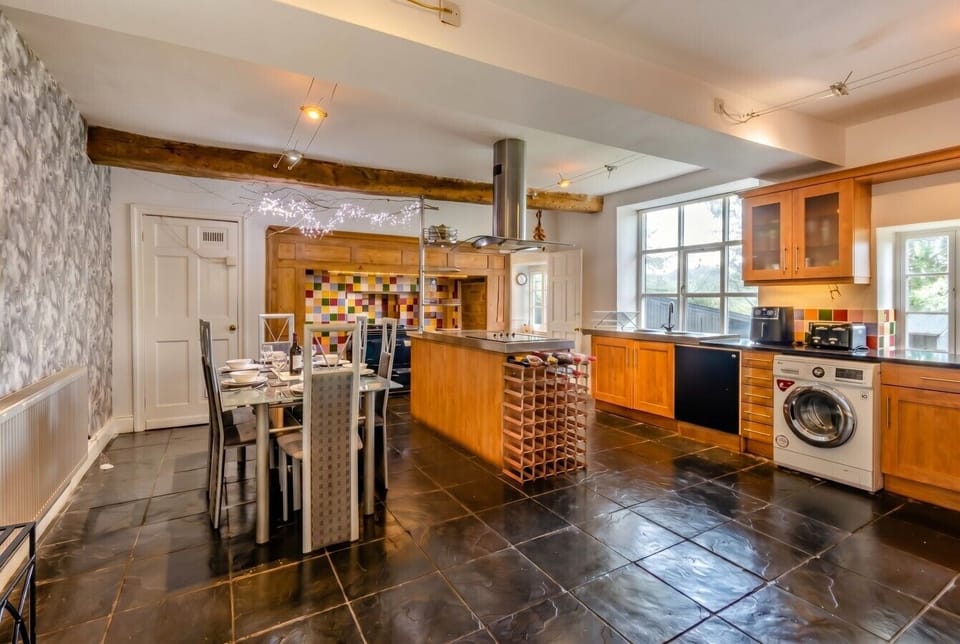 Farmhouse kitchen with island, range and bright dining for the whole group