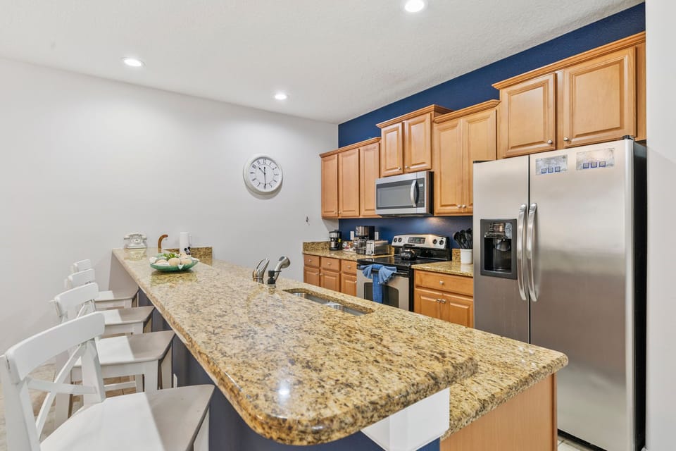 Spacious kitchen featuring granite countertops and stainless steel appliances.