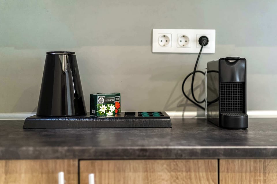 Convenient coffee and tea station with a kettle and espresso maker for easy mornings.