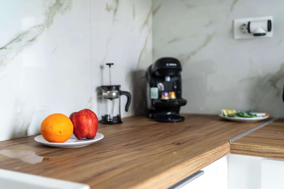 Morning rituals begin here: fresh fruit, coffee essentials, and clean lines in a serene kitchen nook.