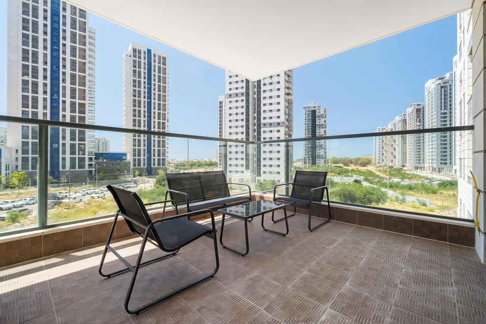 Modern balcony lounge with skyline views, stylish seating, glass railings, and bright urban luxury atmosphere.