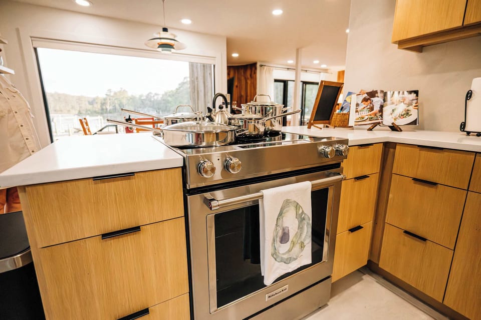 Thoughtfully designed for gathering, the kitchen offers generous workspace and waterfront views.