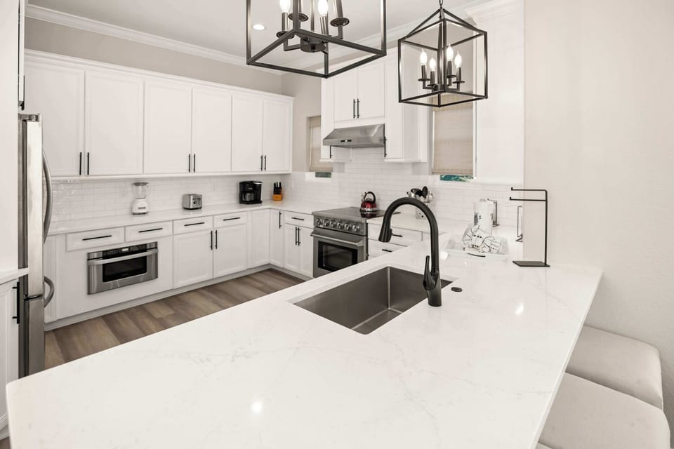 Kitchen: Keurig coffee machine, blender, cooking utensils, tableware