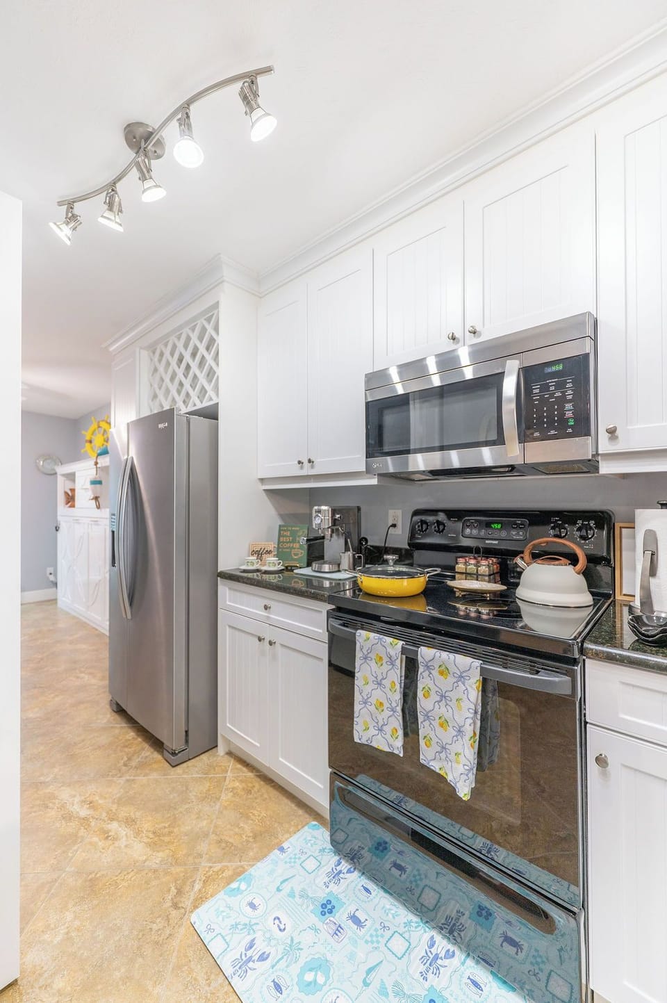 Spacious fully stocked kitchen with stainless steel appliances, espresso machine