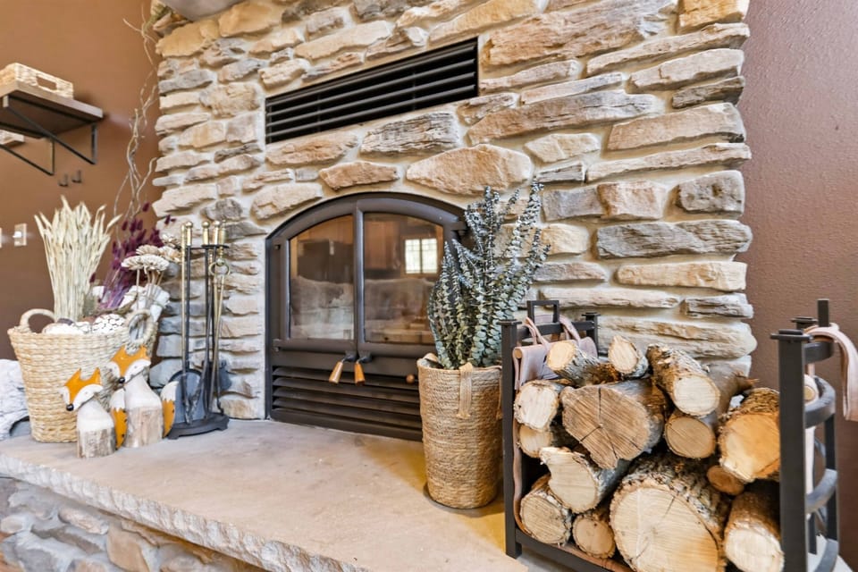 Charming fireside retreat with natural textures, cozy décor, and a relaxed lodge atmosphere.