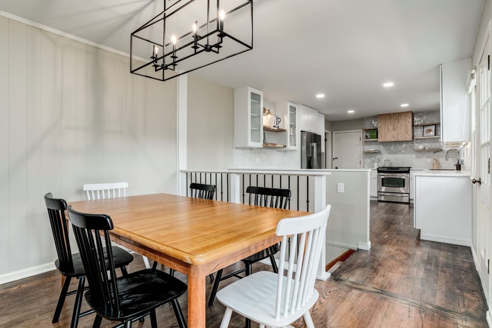 Open dining area with modern kitchen and stylish statement lighting