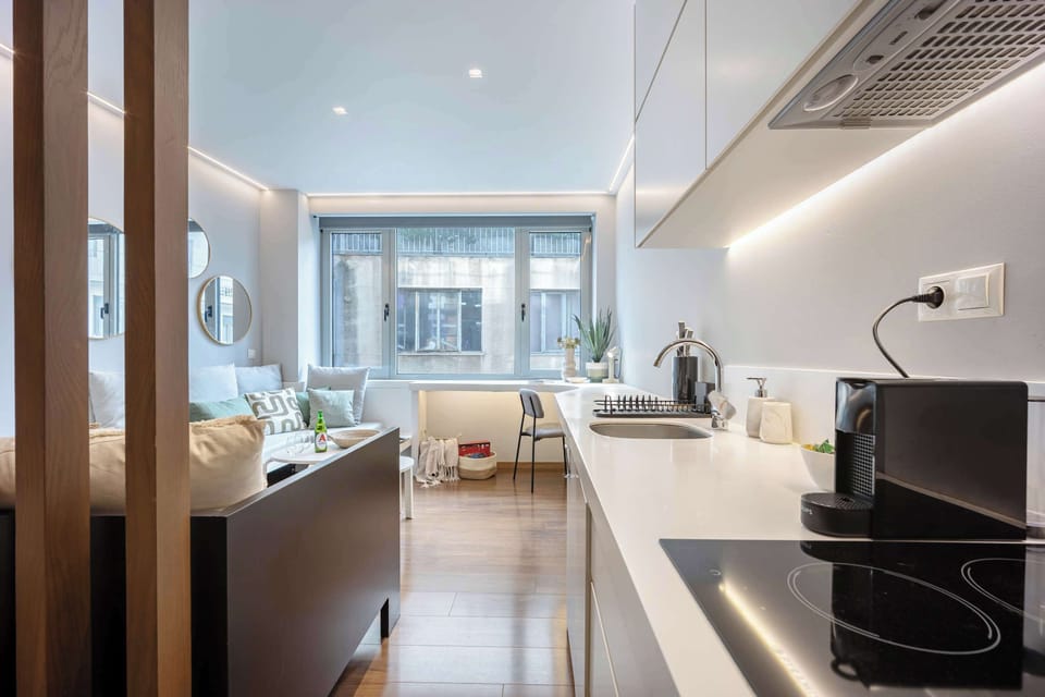 Minimalist cooking zone with glossy counters delivers both style and everyday practicality.