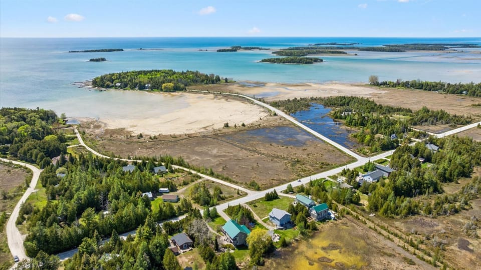 Aerial view showcasing the stunning nearby shoreline and Bruce Peninsula scenery.