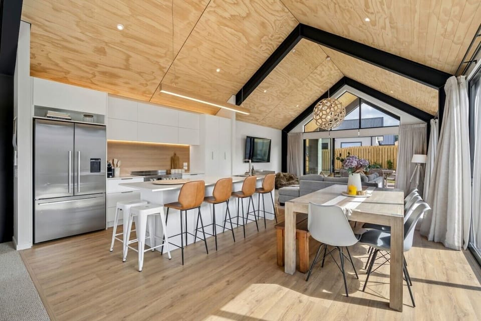 Gourmet kitchen with premium stainless steel appliances, a generous island, and a seamless flow to the outdoor dining area