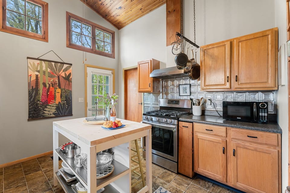 A bright, cozy kitchen with vaulted ceilings — perfect for slow breakfasts, local wine, and quiet evenings in after the lake.
