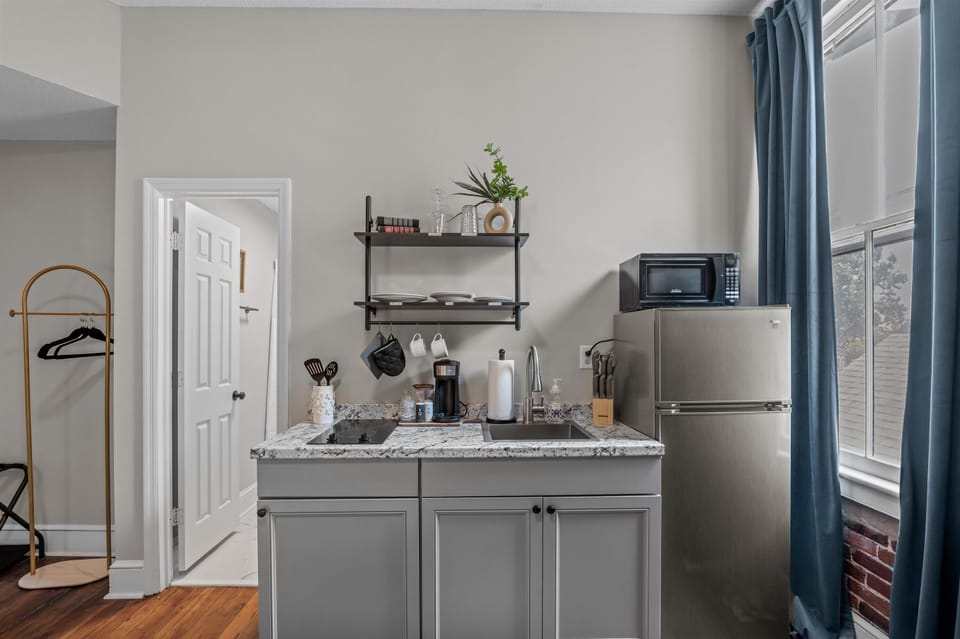 Stovetop double burner, microwave, sink and fridge