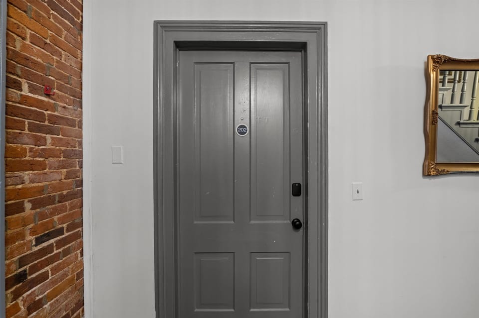 Door to unit, punch in personalized code into smart lock for entry 