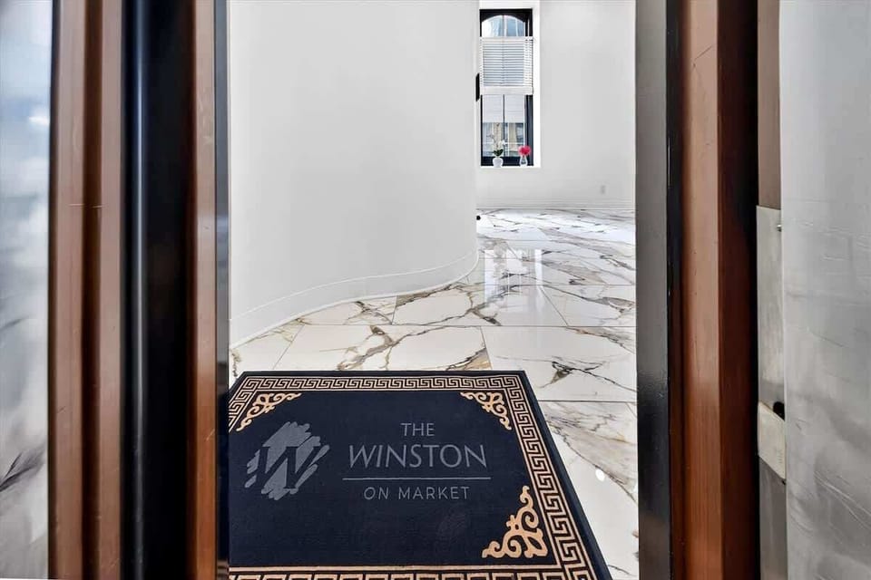 We love this view of the custom welcome mat against the polished marble flooring. It sets the tone for a luxurious stay right from the start.