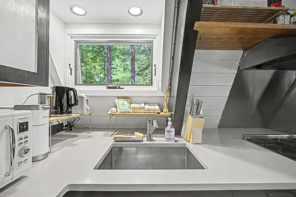 Your fully equipped kitchen offers modern appliances and peaceful forest views, making meal prep a delight during your stay.