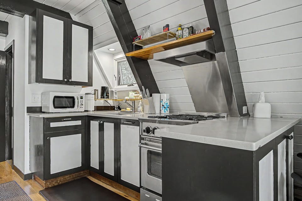 Whip up your favorite meals in this modern full kitchen, equipped with a stove, microwave, and all the essentials you need to feel right at home.