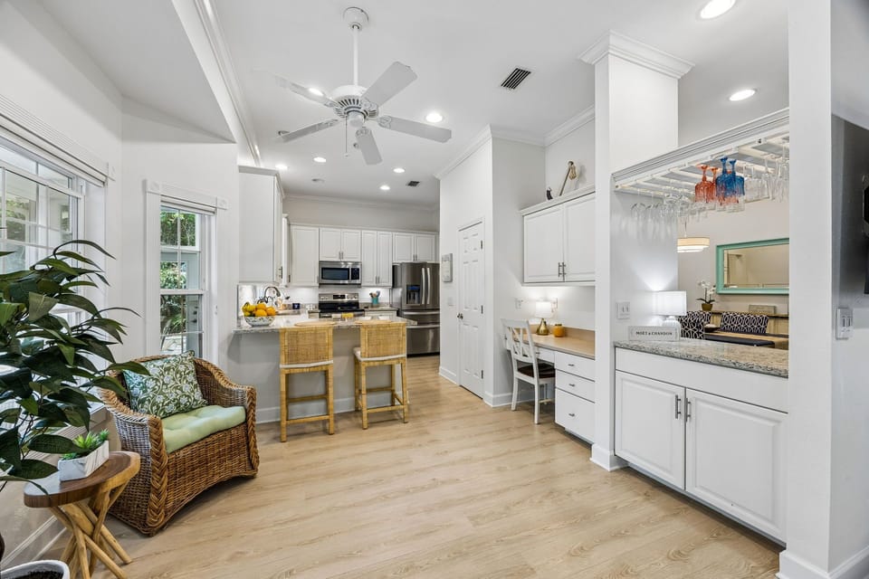 A chef's kitchen built for groups —  A built-in wet bar with hanging stemware rack and a dedicated corner workspace keep things elevated and practical.