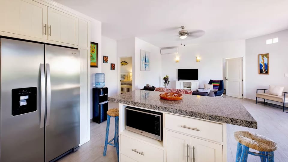 Modern kitchen with stainless steel appliances and a breakfast bar.
