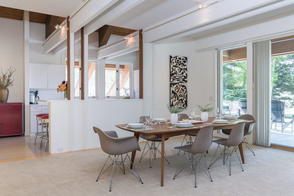 Gather around this beautiful dining table with seating for eight, where you'll enjoy meals together in a bright, open space that flows seamlessly to the outdoor patio through glass doors.