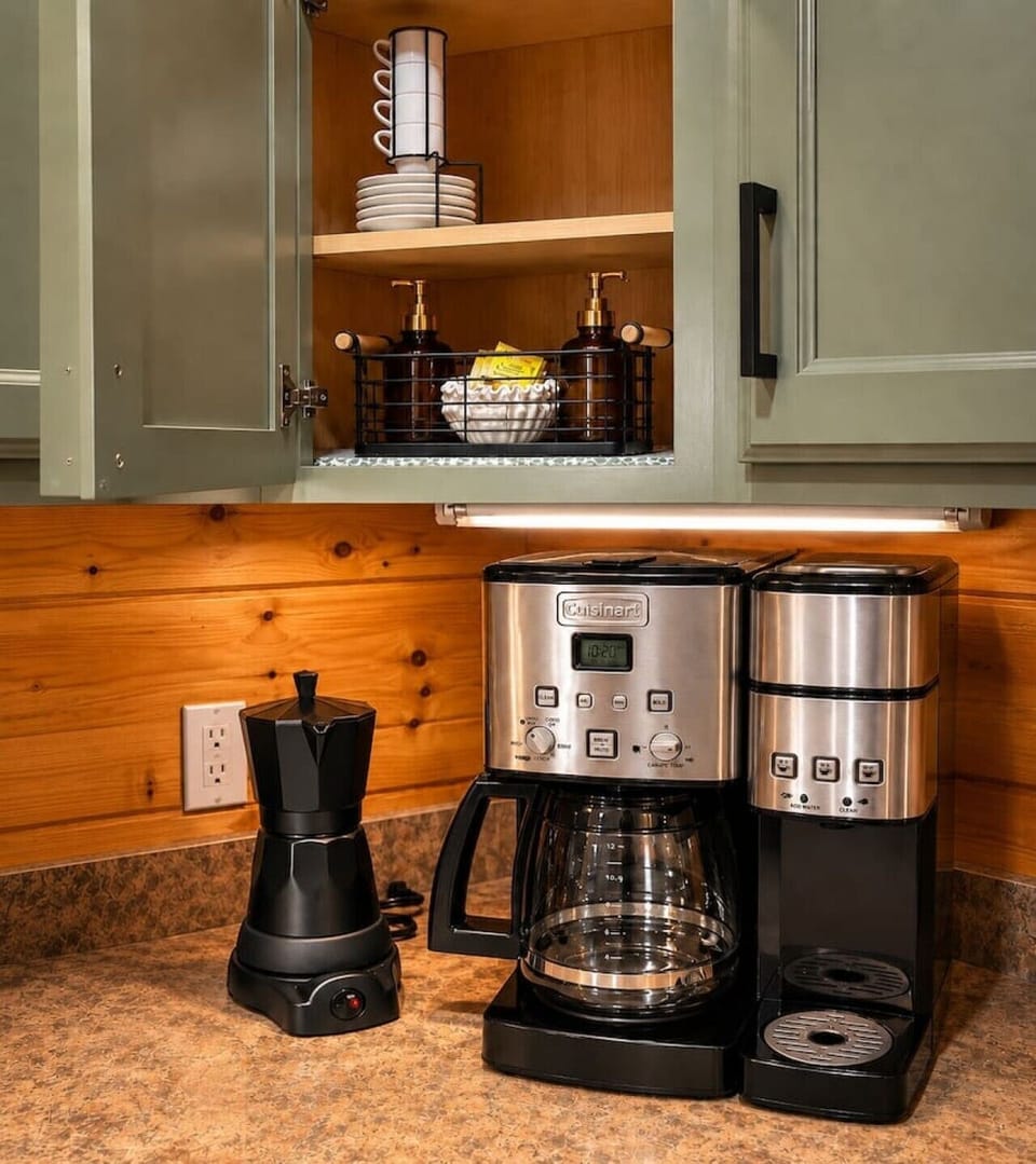 Coffee station with drip coffee maker, Cuban coffee maker, sugar, creamer, and guest essentials for your Smoky Mountain stay.
