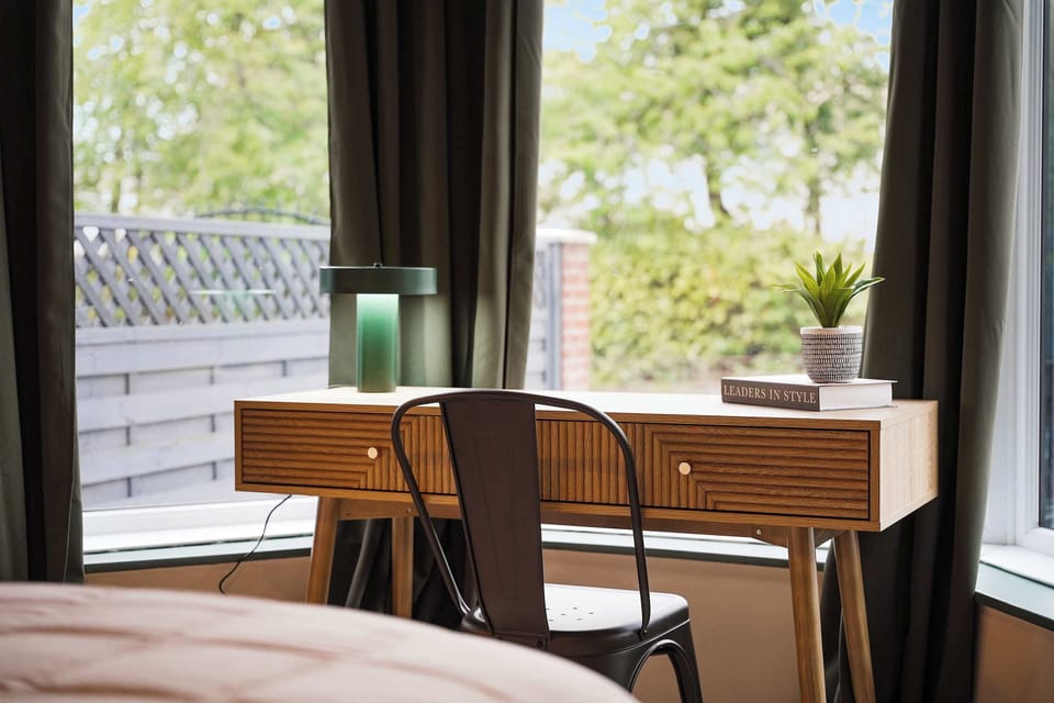 A thoughtfully furnished double bedroom offering a peaceful place to recharge. Complete with practical storage, a dedicated desk area, and stylish bedroom furnishings, the space is well-suited to both productive workdays and restful nights.