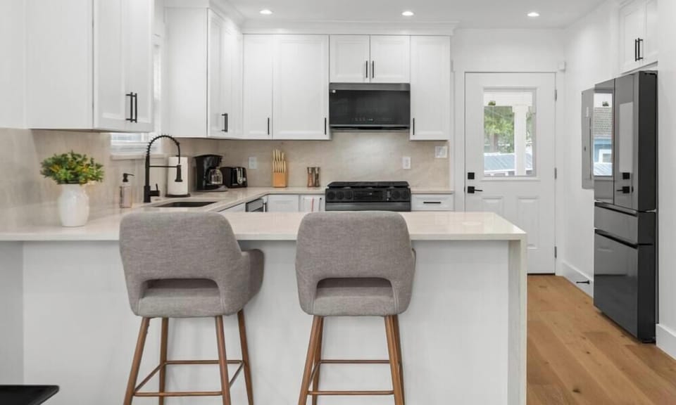 Cook a full group meal at the spacious peninsula with bar seating. White cabinetry and ample counter space keep things organized.