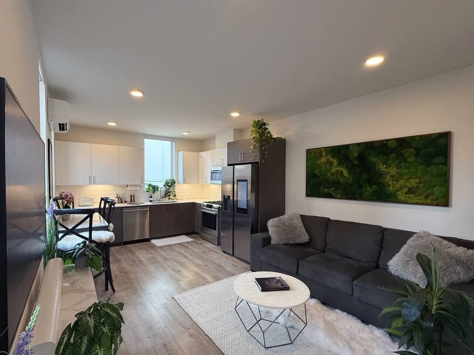 Huge living moss wall, wool and fur rugs, fur pillows, and American Leather luxury couch w/ King size memory foam pullout bed (full linens, down pillows, down comforter provided ). 65” Frame artwork TV with Sonos Arc sound bar for entertainment. 