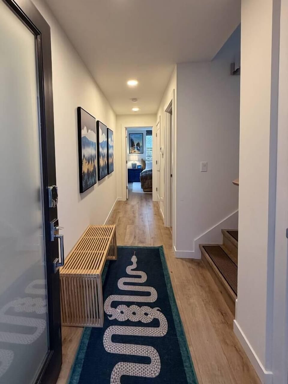 Entry hallway bench for shoes, with guest bathroom, laundry closet and access to Kingsize bedroom. 