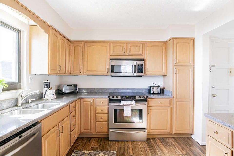 Bright, modern kitchen with stainless steel appliances and natural light