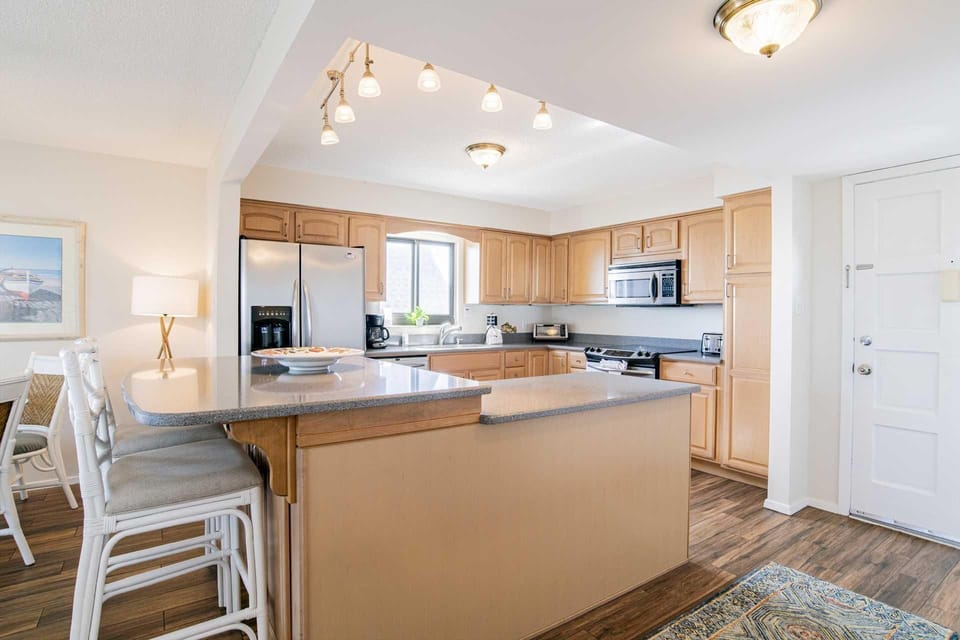 Spacious kitchen with breakfast bar and modern appliances
