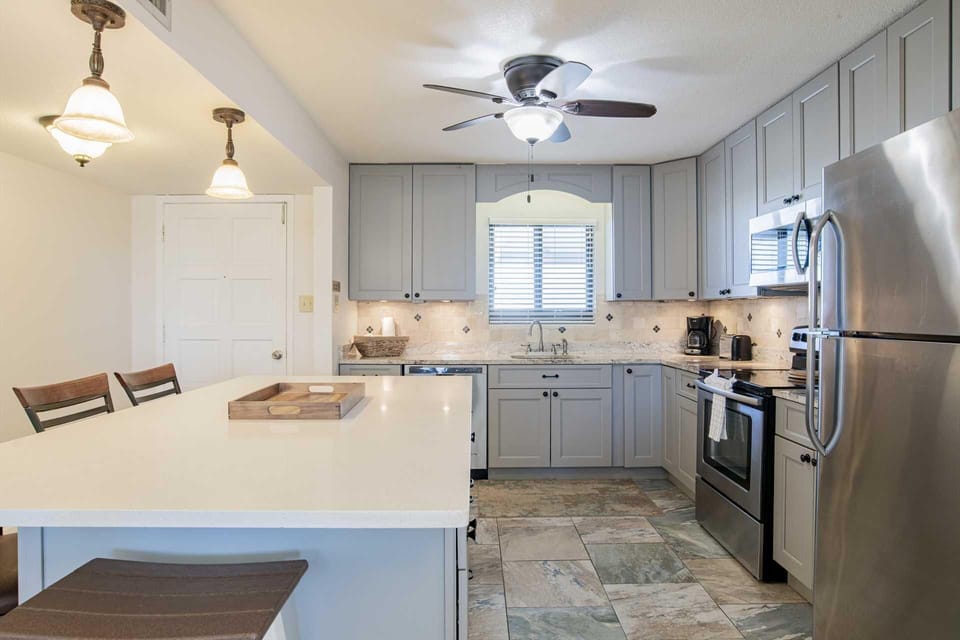 Bright, modern kitchen with spacious island and stainless steel appliances
