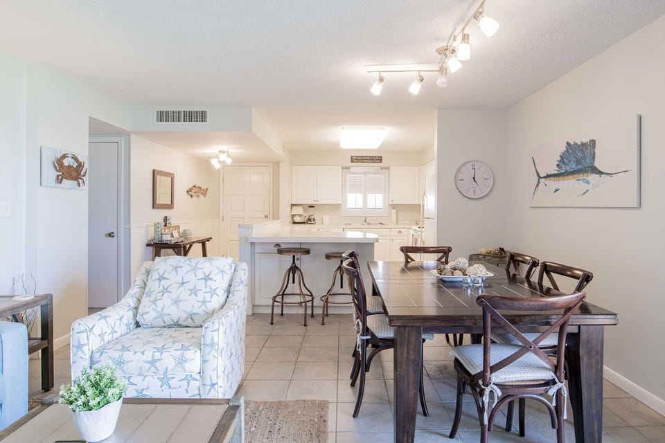 Bright open living and dining area with cozy seating and modern kitchen