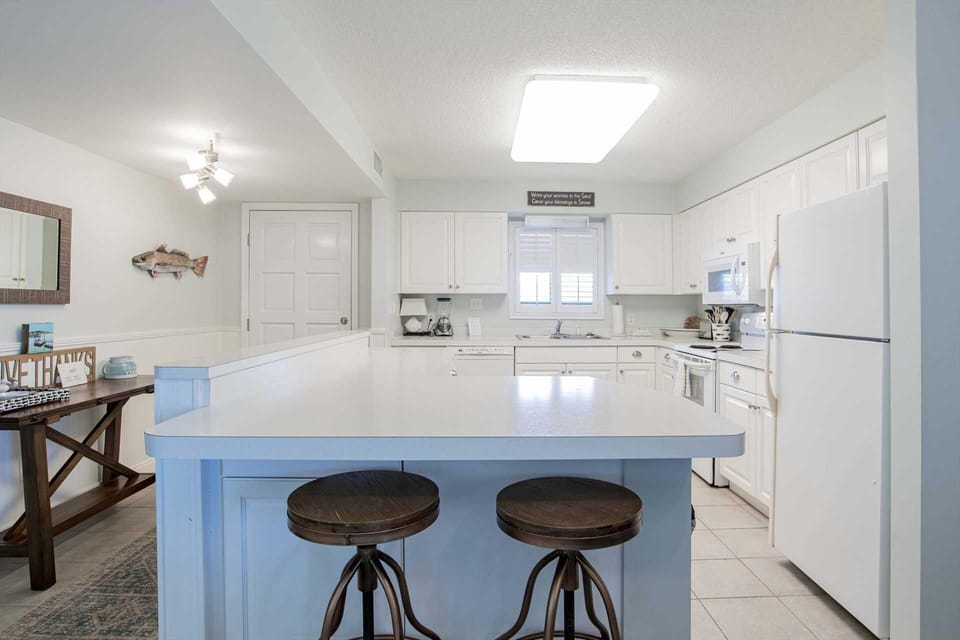 Bright, airy kitchen with spacious island and cozy seating