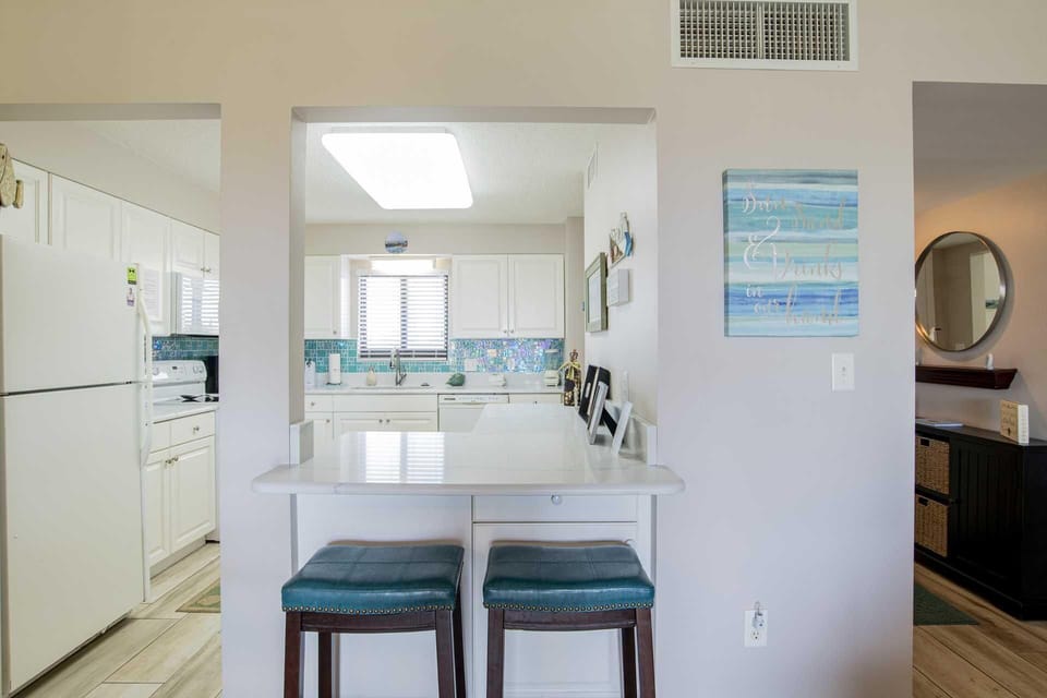 Bright kitchen with breakfast bar and ocean-inspired decor