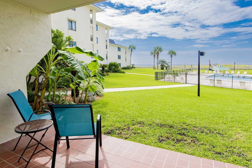 Relax on the shaded patio overlooking lush green lawns and Gulf views