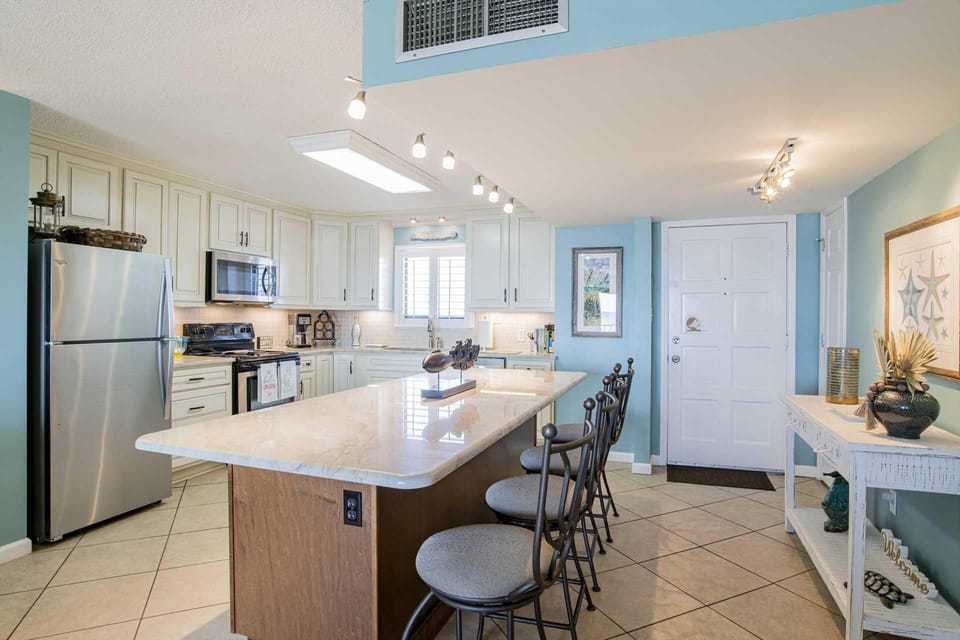 Bright, modern kitchen with spacious island and stainless steel appliances