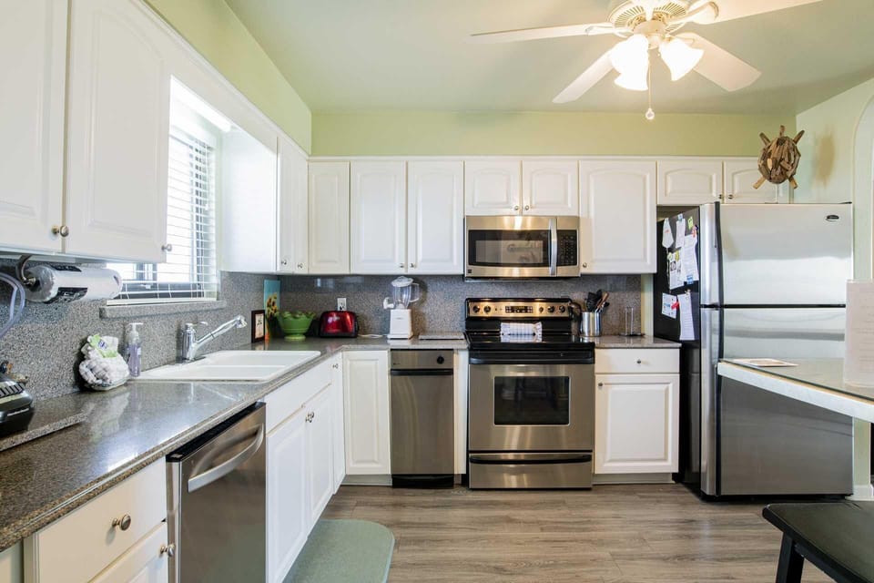 Bright, modern kitchen with stainless steel appliances and natural light