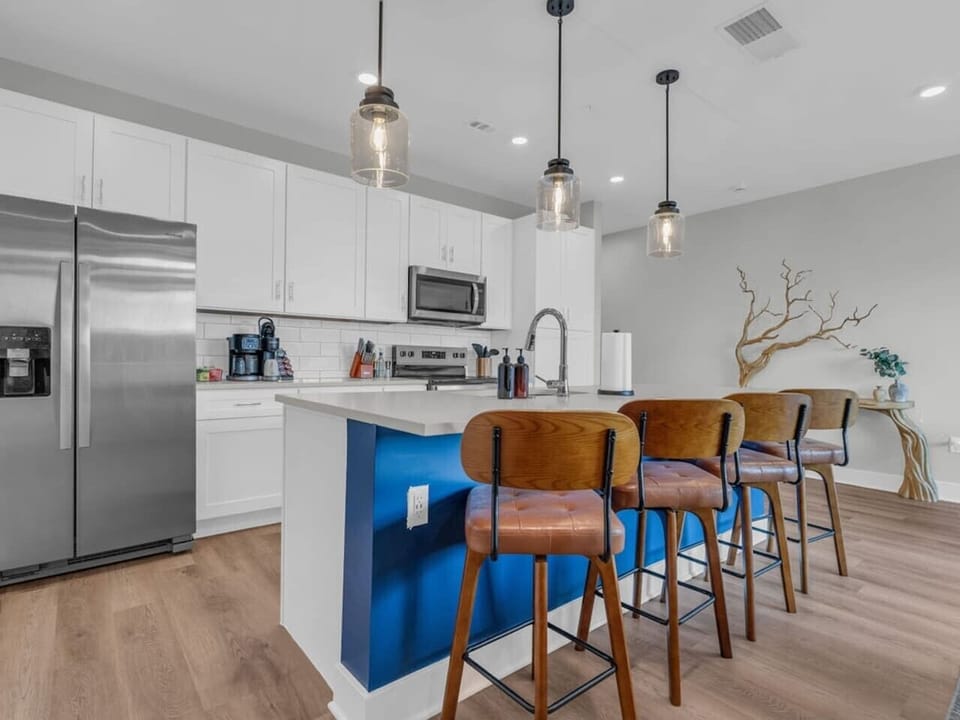 Kitchen: Sleek design with stylish seating and top-notch appliances for culinary creativity!