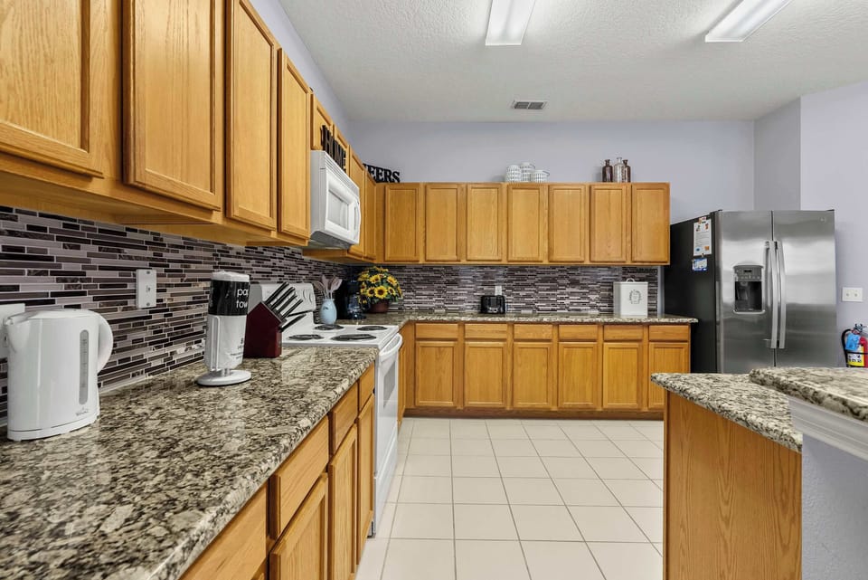 Spacious kitchen with granite countertops and stainless steel appliances for convenient cooking.