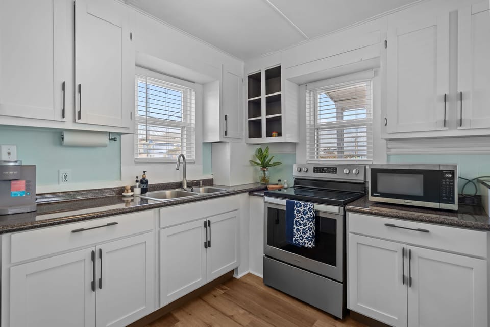 Fully equipped kitchen with modern appliances and natural light